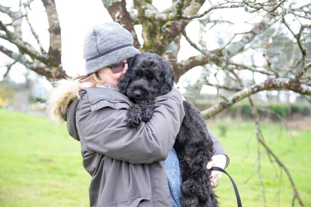 istock mature woman with cute black dog 1211622563