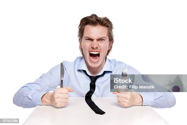 Angry Looking Young Man Banging His Cutlery On The Table Stock Photo - Download Image Now