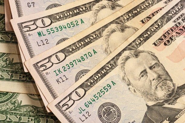 istock Close-up of multiple American dollar banknotes. 1211623982