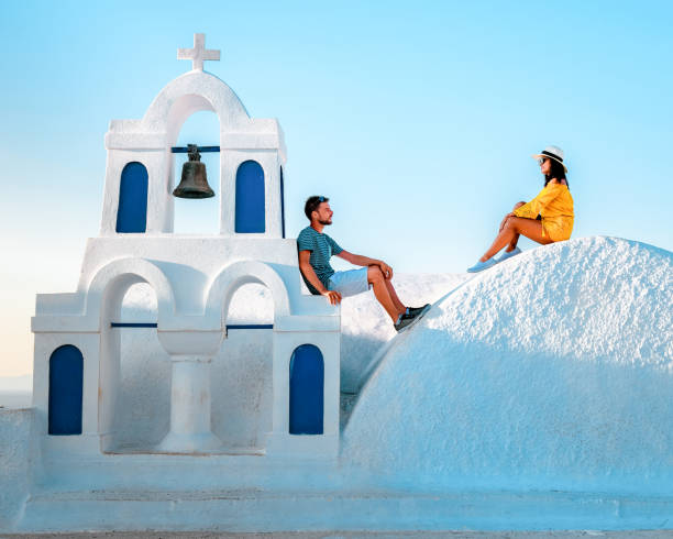 couple honeymoon on vacation Greece visisting Oia Santorini, man and girl on holiday in Greece on a luxury trip to Oia whitewashed village with Greek churches couple honeymoon on vacation Greece visisting Oia Santorini, man and girl on holiday in Greece on a luxury trip to Oia whitewashed village with Greek churches Europe happy couple on vacation in santorini greece stock pictures, royalty-free photos & images