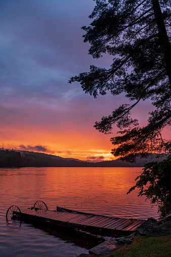 A view of sunset over a lake in central Maine in the summer.