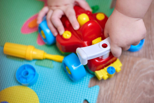 istock The boy plays with a car that can be disassembled. 1211625044