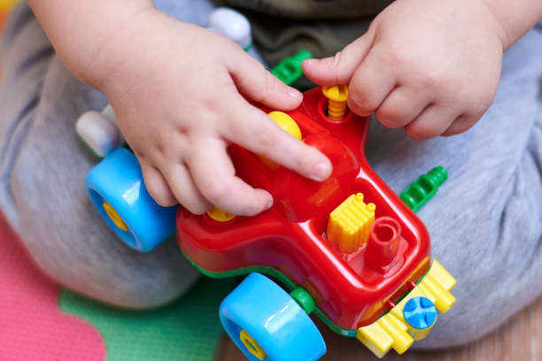 istock The boy plays with a car that can be disassembled. 1211625225