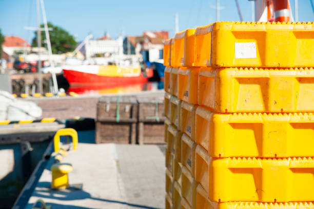 Yellow plastic fish crates on the wharf