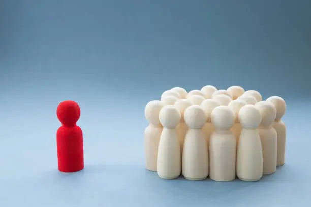 Photo of A Manager or Leader addressing a group of people or being isolated because of diversity