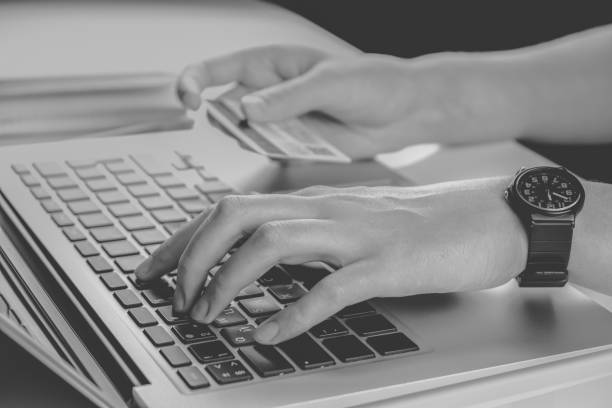 istock Using credit card for online payment, low key monochrome. 1211628990