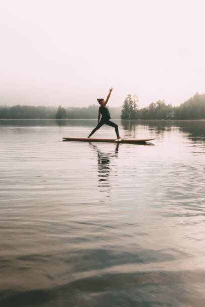 istock Young Woman Practicing Yoga On A Paddleboard 1211629080