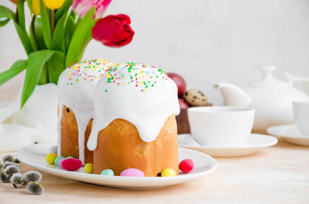 istock Easter composition. Easter Cake - Russian and Ukrainian Traditional Kulich with easter eggs on a light stone background. Paska Easter Bread. Selective focus. Horizontal orientation. Copy space 1211629443