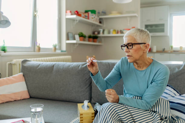 istock Sick Woman with a Cold Measuring Temperature 1211630581