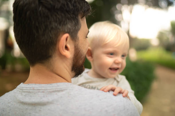 istock Father with son on lap enjoying the weekend 1211630669