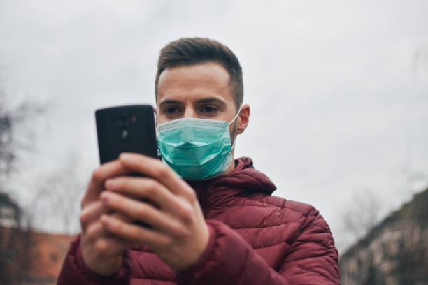 istock Men In Town Wearing Protective Face Mask 1211631000
