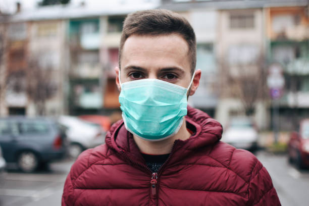 istock Men In Town Wearing Protective Face Mask 1211631042
