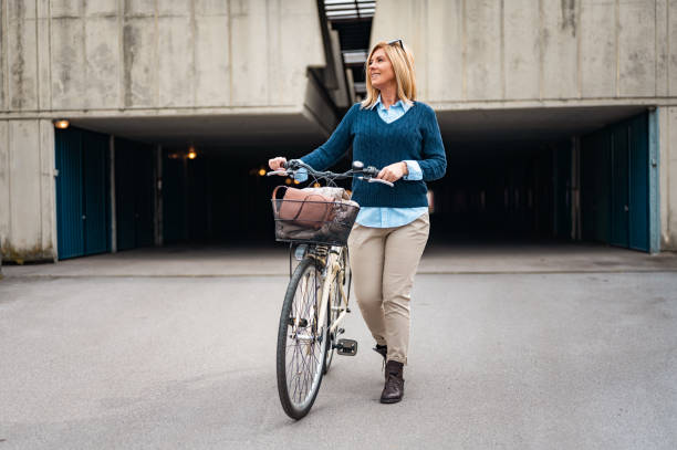istock Woman walking with a bicycle 1211631096