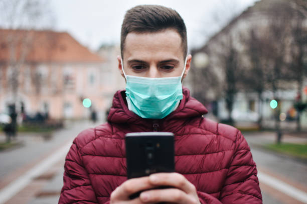 istock Men In Town Wearing Protective Face Mask 1211631123