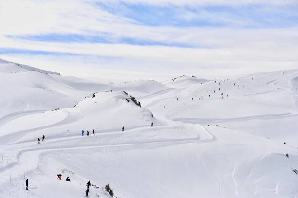 istock Ski slope with skiing people in winter 1211631131