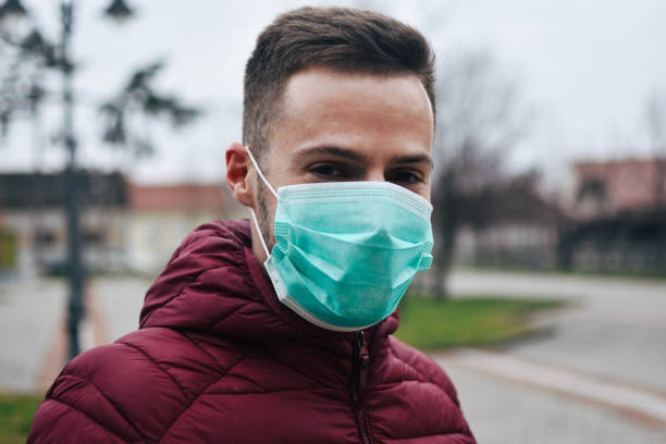 istock Men In Town Wearing Protective Face Mask 1211631214