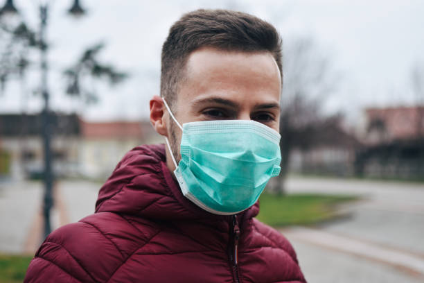 istock Men In Town Wearing Protective Face Mask 1211631216