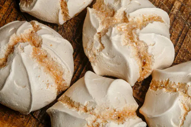 Traditional latin american dessert called suspiro or meringue. On wooden table