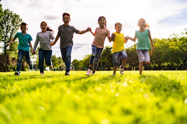 istock Happy kids on the grass 1211632061