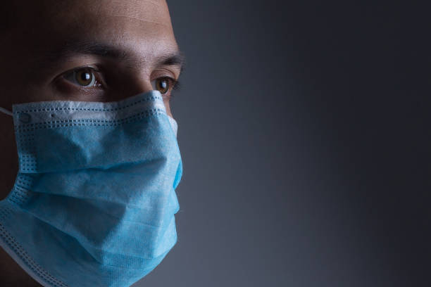 uomo che indossa la maschera per prevenire il virus influenzale e l'inquinamento atmosferico da polvere su sfondo bianco - swine flu immagine foto e immagini stock