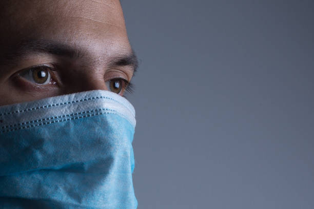 istock Strong man wearing mask to prevent flu virus and dust air pollution on white background 1211633585