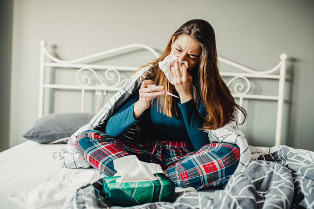 istock Sick woman in bed 1211634384