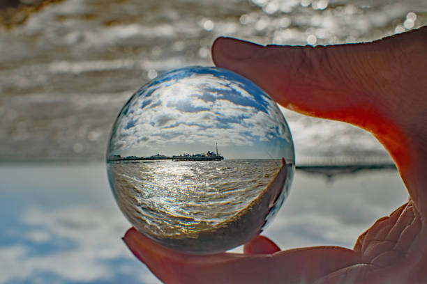 Fishing boats and old quays with the city view through lensball