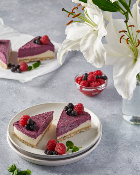 istock raw vegan double-layer cake with black currant on a light gray background under a concrete texture. Healthy eating, delicious dessert without baking 1211635079