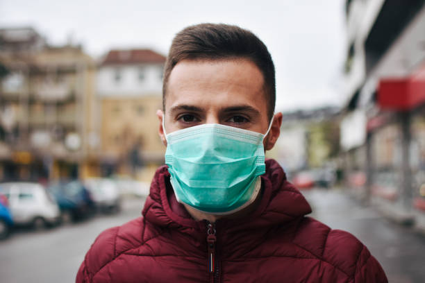 istock Men In Town Wearing Protective Face Mask 1211636129