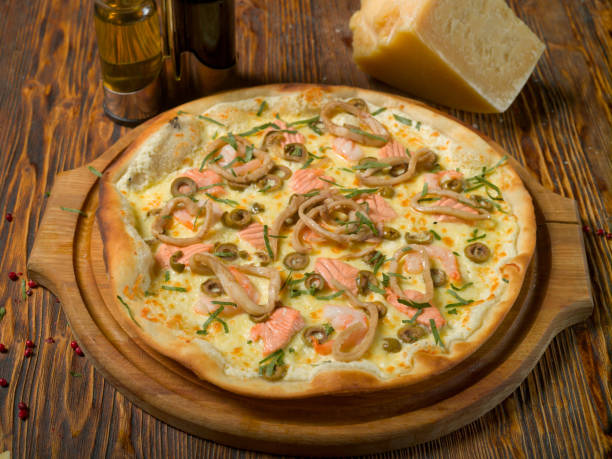 istock Seafood pizza on a wooden table 1211636161