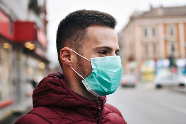 istock Men In Town Wearing Protective Face Mask 1211636235