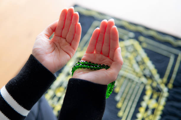 donna musulmana che prega - abbigliamento modesto foto e immagini stock