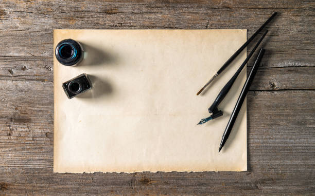 istock Letter paper writing tools Ink pen inkwell Vintage background 1211637018