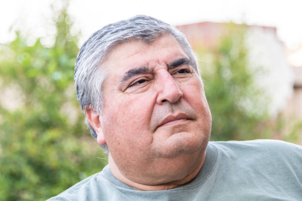 istock Overweight mature senior man looking away 1211637714