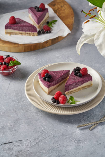 istock raw vegan double-layer cake with black currant on a light gray background under a concrete texture. Healthy eating, delicious dessert without baking 1211639186