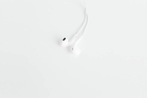 istock White earphones on the white background.Space for text,mockup.Minimalism. 1211639236