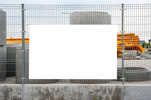 Blank white banner mockup on the fence of construction site