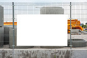 Blank white banner mockup on the fence of construction site
