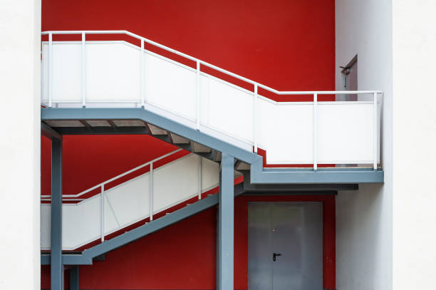 istock White external staircase of modern building with red wall. Emergency exit 1211641217