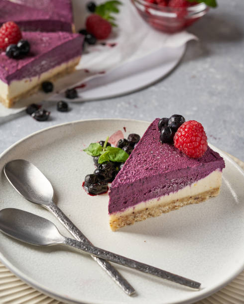 istock raw vegan double-layer cake with black currant on a light gray background under a concrete texture. Healthy eating, delicious dessert without baking 1211641353