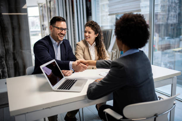 istock Young business couple signing a contract 1211642763