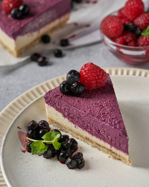 istock raw vegan double-layer cake with black currant on a light gray background under a concrete texture. Healthy eating, delicious dessert without baking 1211642845