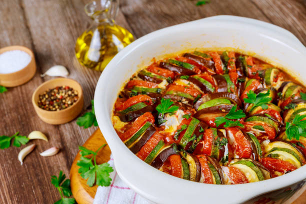 istock Stewed vegetable ratatouille with mozzarella cheese in white oven pan. 1211642858