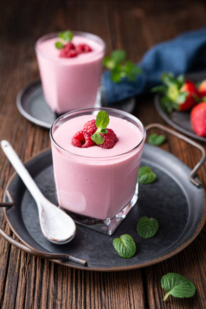 Healthy drink, strawberry and raspberry smoothie with Greek yogurt in a glass jar stock photo