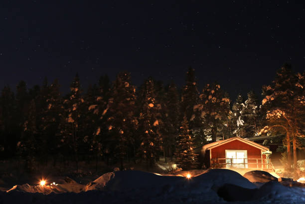 istock Log Cabin at Winter Night in Swedish Lapland 1211645628