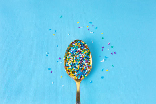Microplastic in a spoon on blue background. microplastic in water and food. Microplastic problem. Dangerous additives. Toxic substances. Microplastic in a spoon on blue background. microplastic in water and food. Global ocean pollution. Microplastic problem. Threat to human health and the environment. Dangerous additives. Toxic substances. microplastic stock pictures, royalty-free photos & images