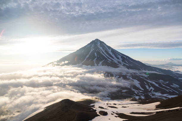 Koryaksky volcano, Kamchatka peninsula, Russia. An active volcano 35 km north of the city of Petropavlovsk-Kamchatsky. The absolute height is 3430 meters above sea level. Koryaksky volcano, Kamchatka peninsula, Russia. An active volcano 35 km north of the city of Petropavlovsk-Kamchatsky. The absolute height is 3430 meters above sea level. sulphur landscape fumarole heat stock pictures, royalty-free photos & images