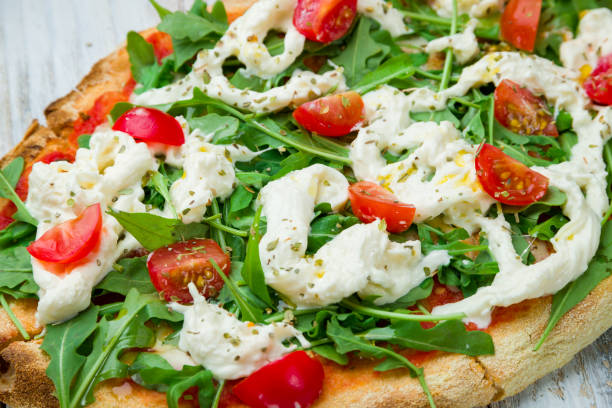 Pinsa with tomatoes, aragula and stracciatella. rome pizza