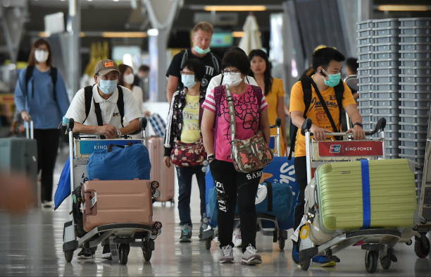 Air Travelers Wear Masks as a Precaution against Covid-19 stock photo