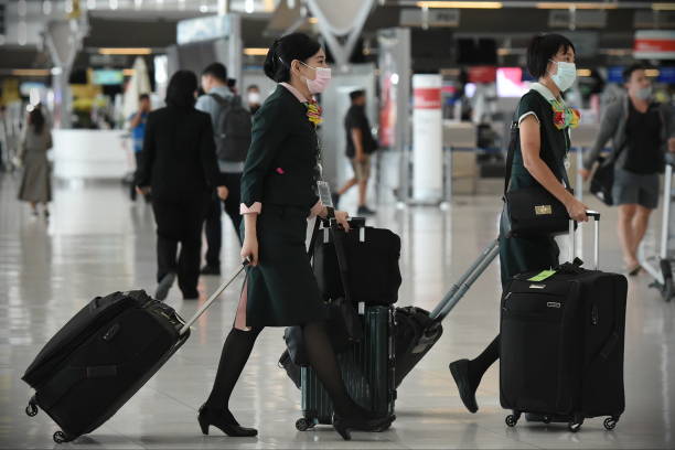 Air Travelers Wear Masks as a Precaution against Covid-19 stock photo